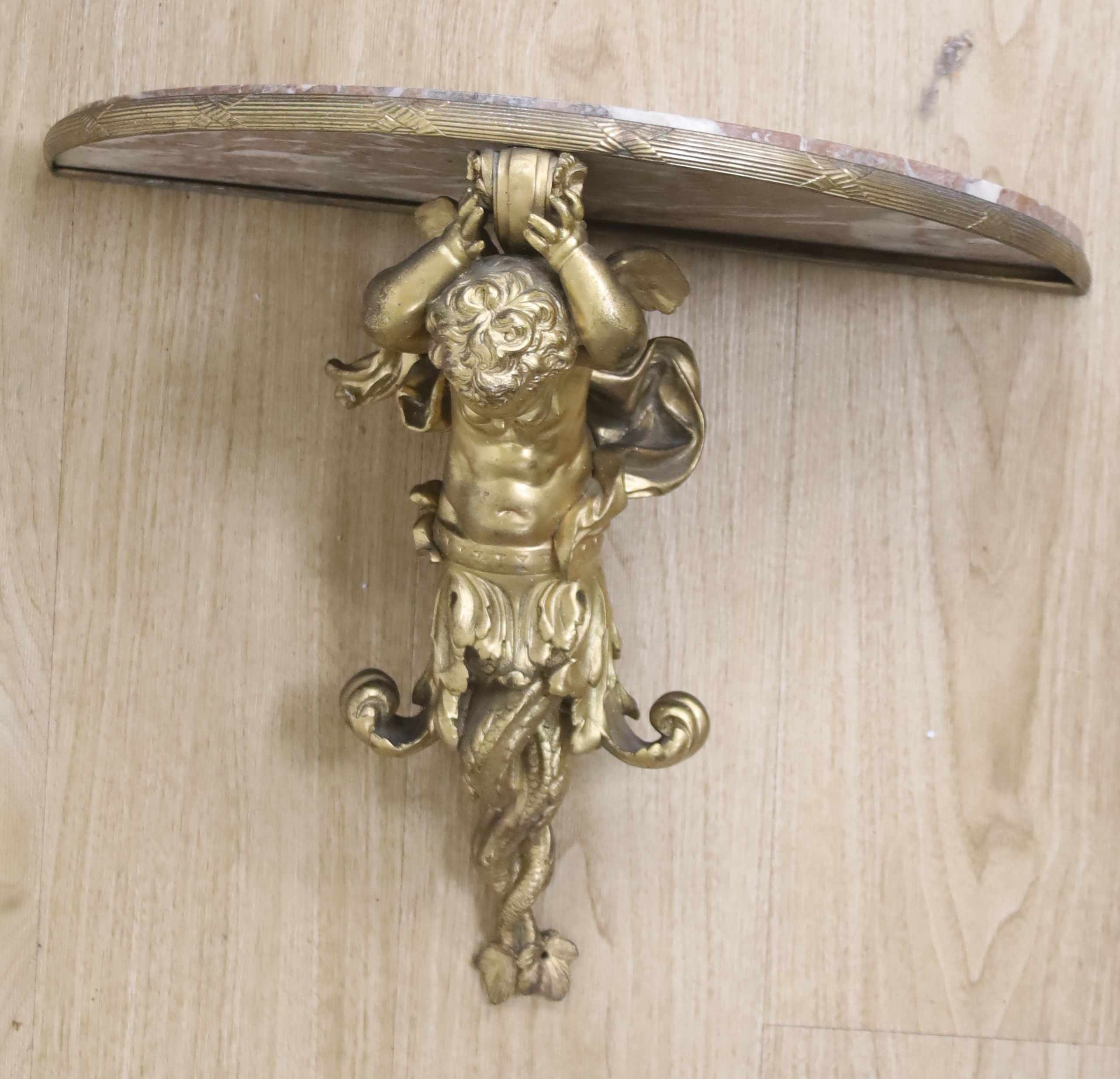 A Louis XV style gilt cast metal marble-topped wall bracket, 52cm wide, 49cm wide